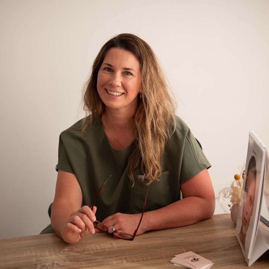 Anna Hammond, Registered Nurse, smiling at her consultation desk